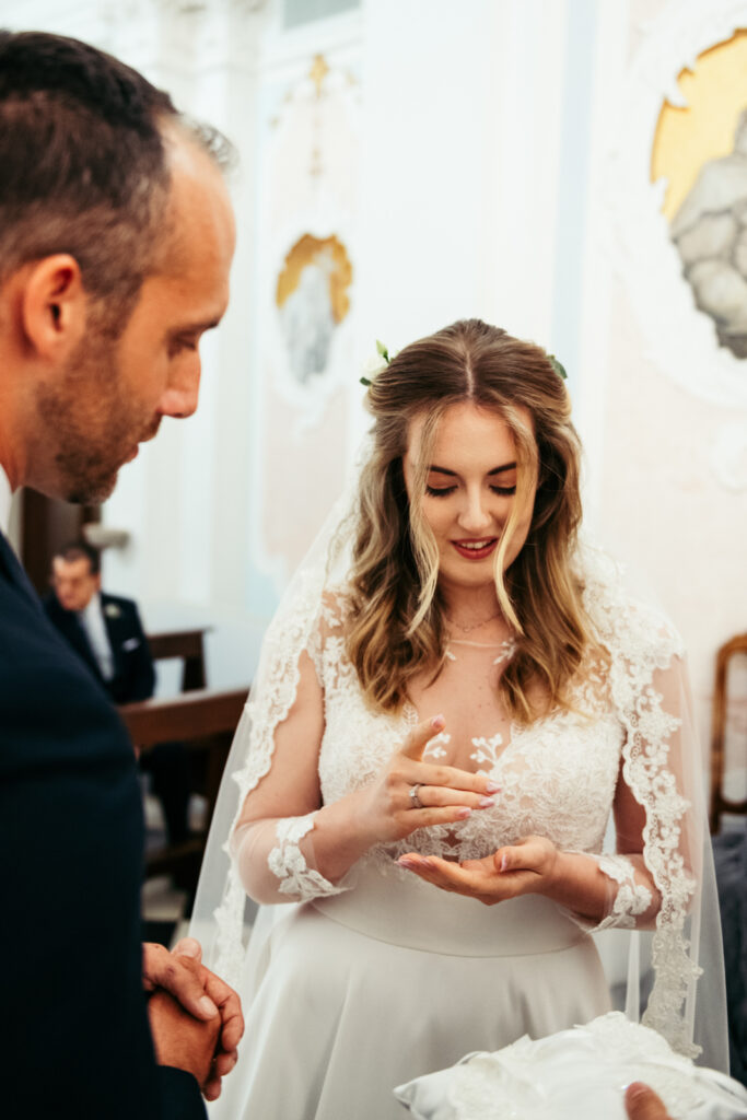 Couple exchanging rings during their intimate wedding ceremony in Italy.