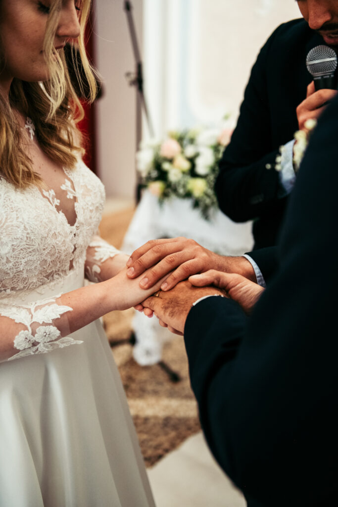 Close-up of bride and groom's hands after the ring exchange