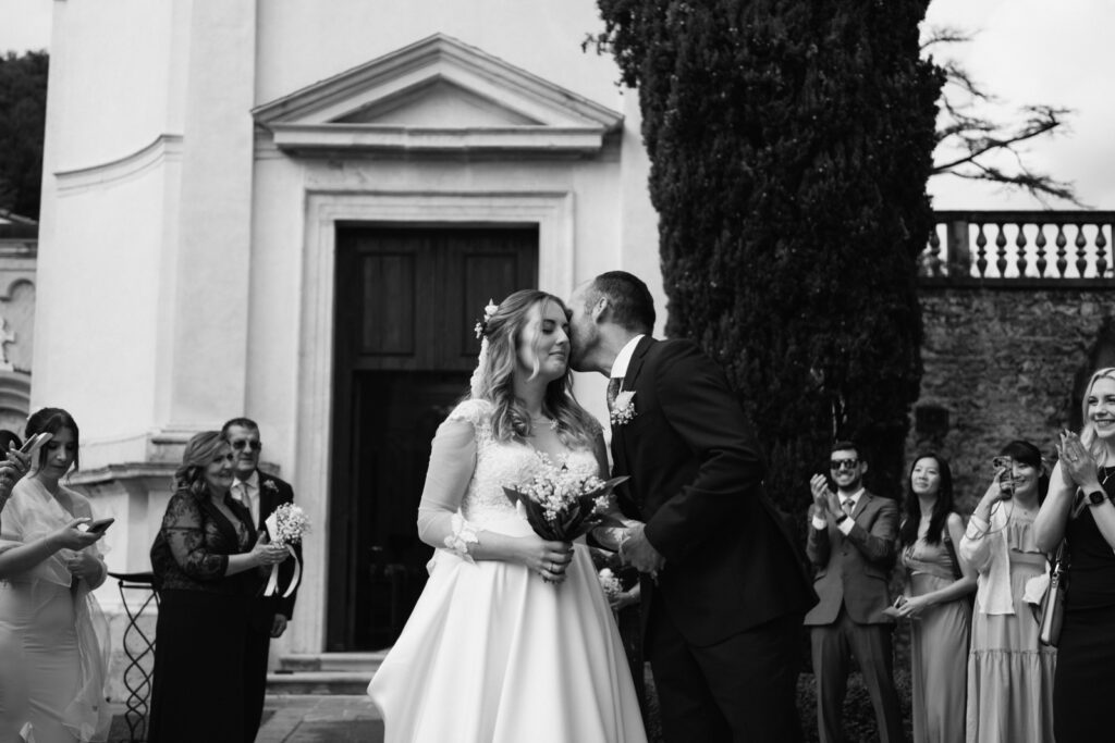 Bride and groom smiling and kissing after their micro-wedding ceremony at CastelBrando.