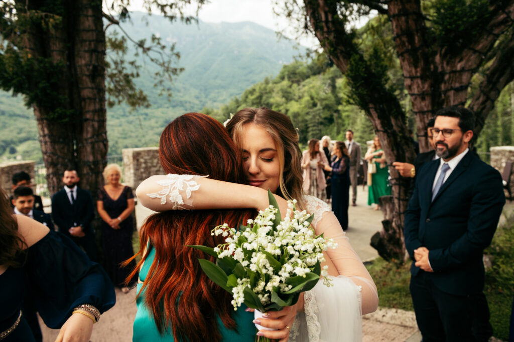 Bride hugging a friend after the ceremony