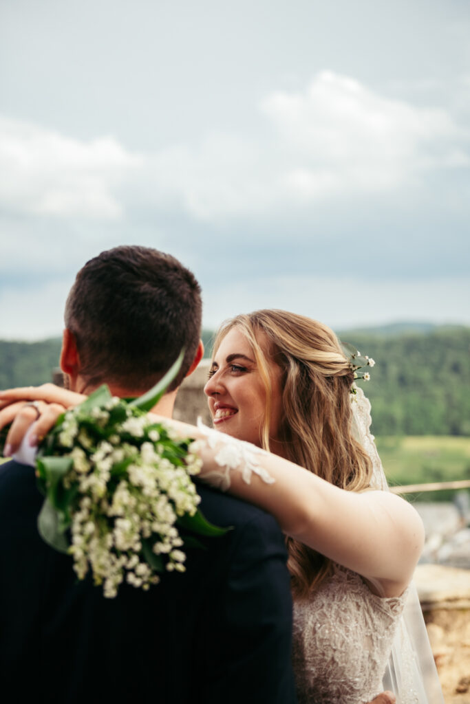 Bride smiling at her husband during golden hour portraits at CastelBrando.