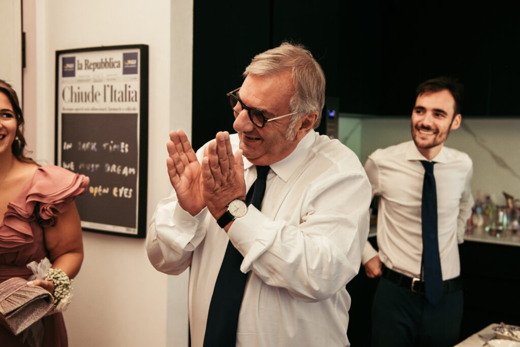 Father clapping emotionally as he sees the bride ready for the first time