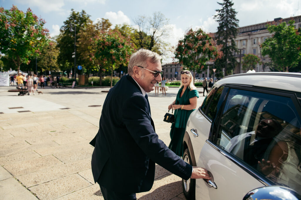 Father of the bride opening the car door for the bride