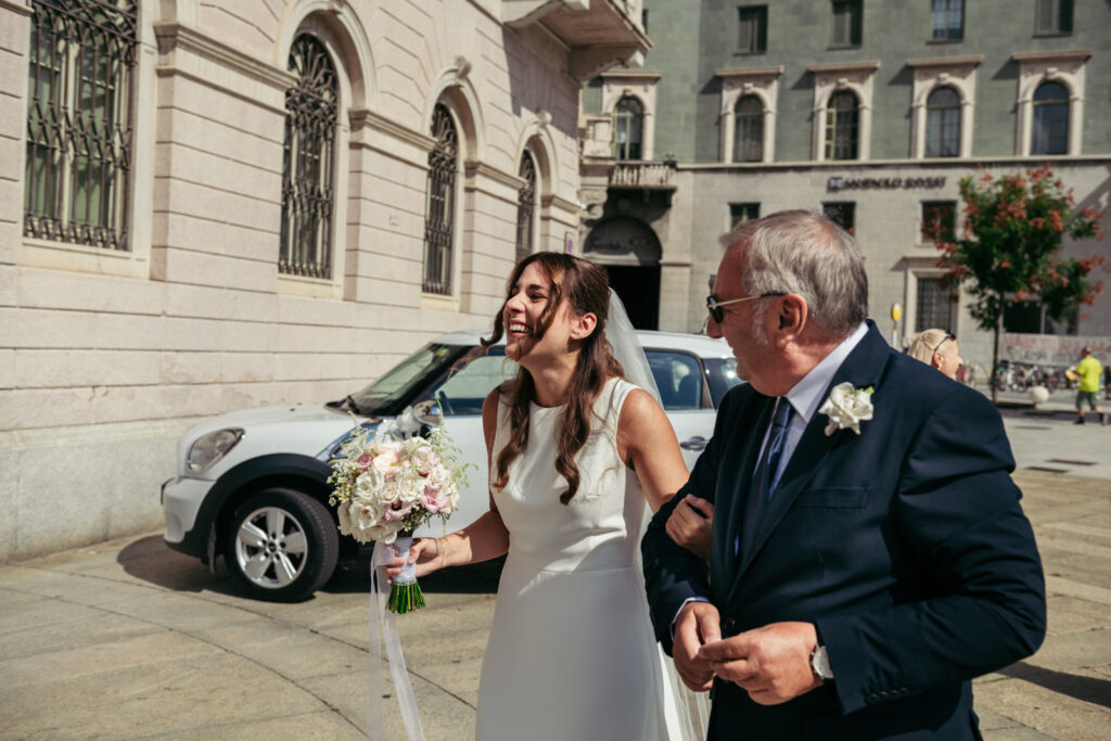 Bride walking with her father toward the car after the ceremony