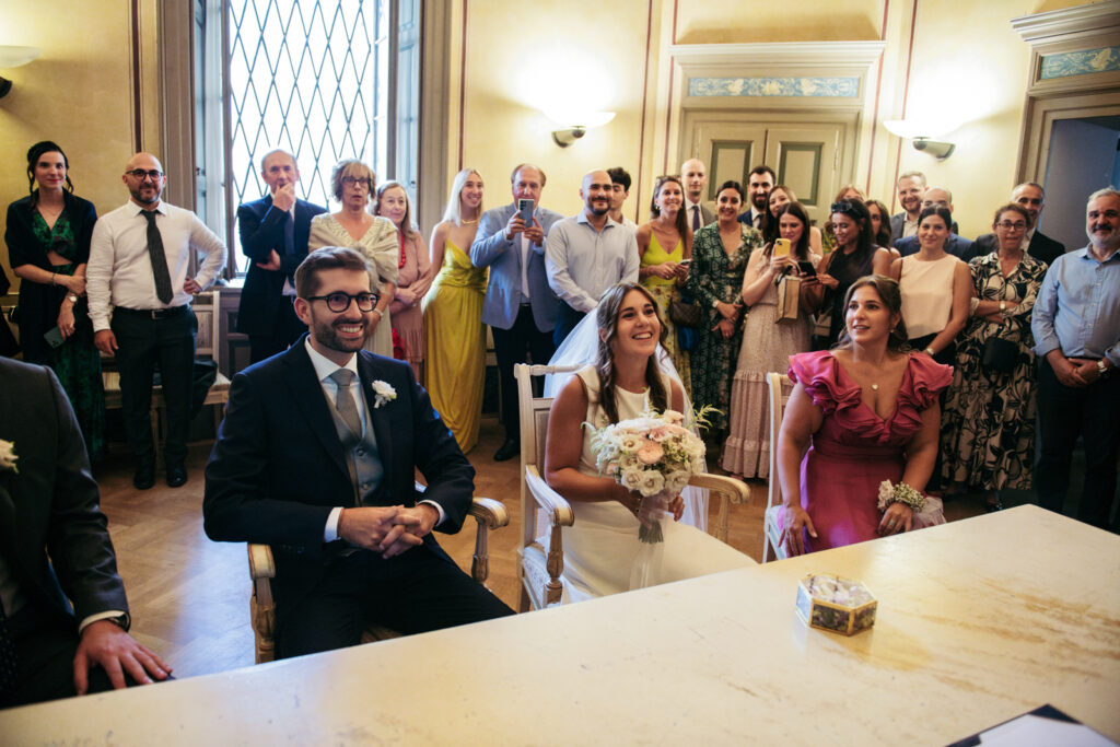 Group of guests standing for the official moment of the wedding