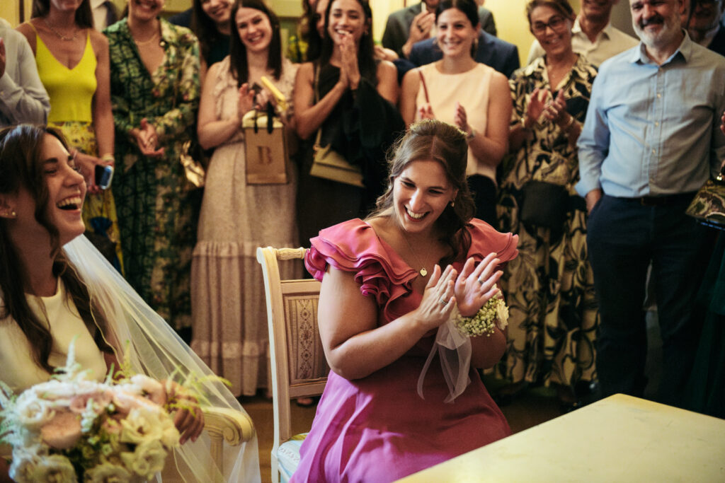 Bridesmaid clapping during the civil ceremony celebration