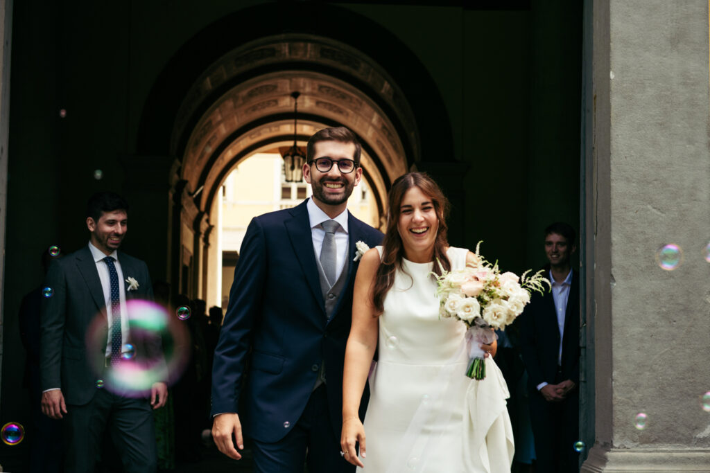 Newlyweds walking through the arched doorway after their civil wedding