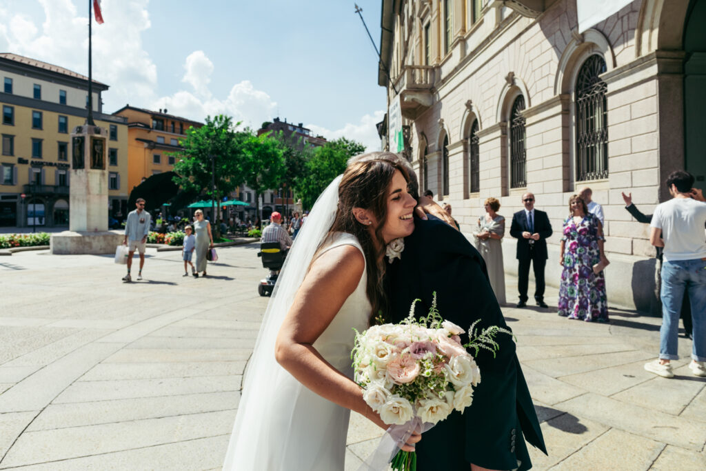 Bride smiling while greeting guests after the ceremony in Bergamo