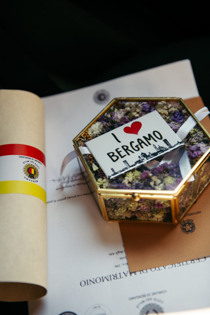 Decorative souvenir labeled “I love Bergamo” and wedding certificate