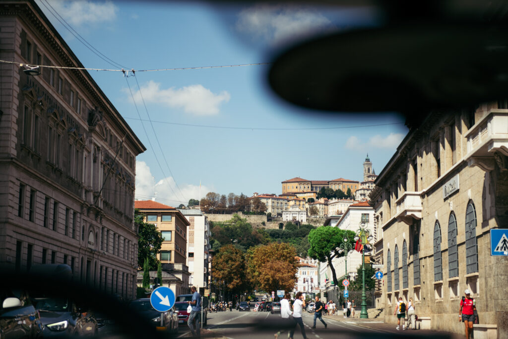 View of the historic center of Bergamo Alta with people walking in the square
