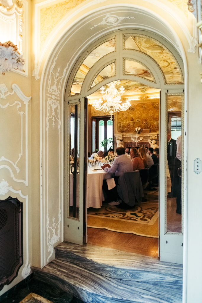 View through the arched doorway into the elegant wedding reception room at Villa Elena