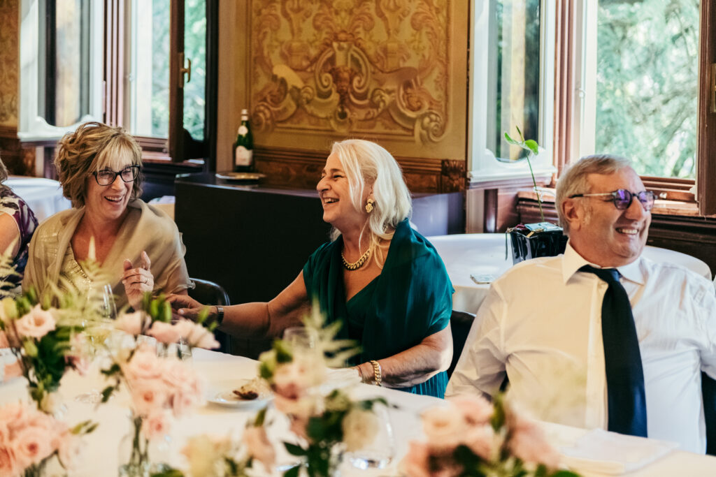 Family members chatting and smiling inside the frescoed reception room