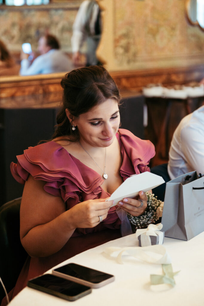 Bridesmaid reading a handwritten note during the celebration