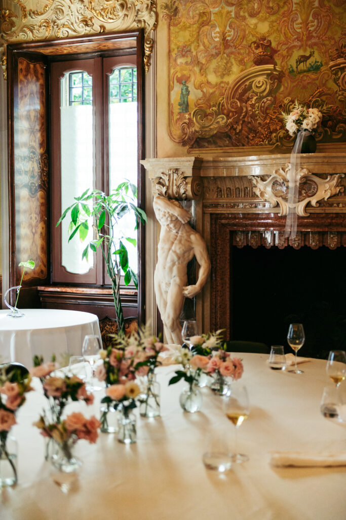 Table decor with floral centerpieces in the historic reception room of the villa