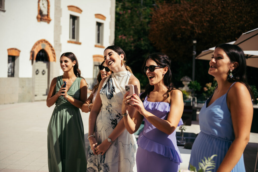 Guests raising glasses and taking photos during the couple’s entrance