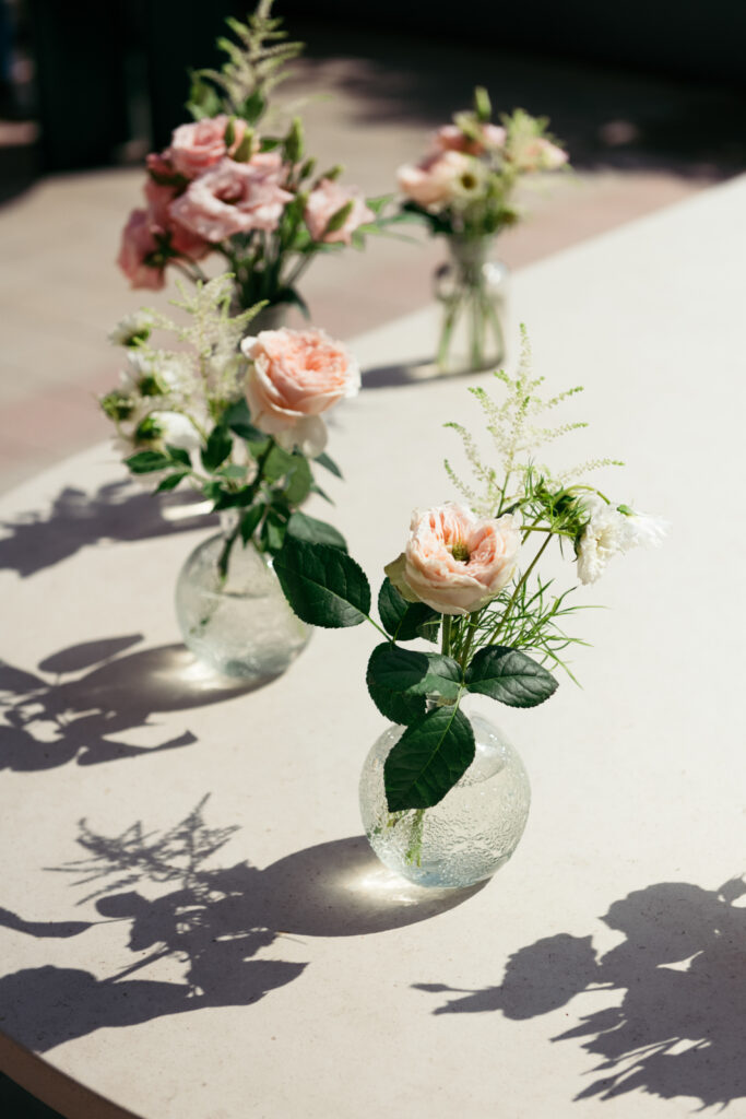 Elegant floral arrangement with pastel roses on the reception table