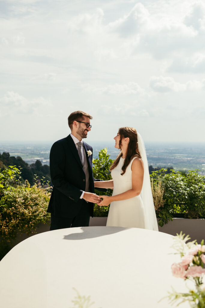 Bride and groom sharing a quiet moment with panoramic views of Bergamo
