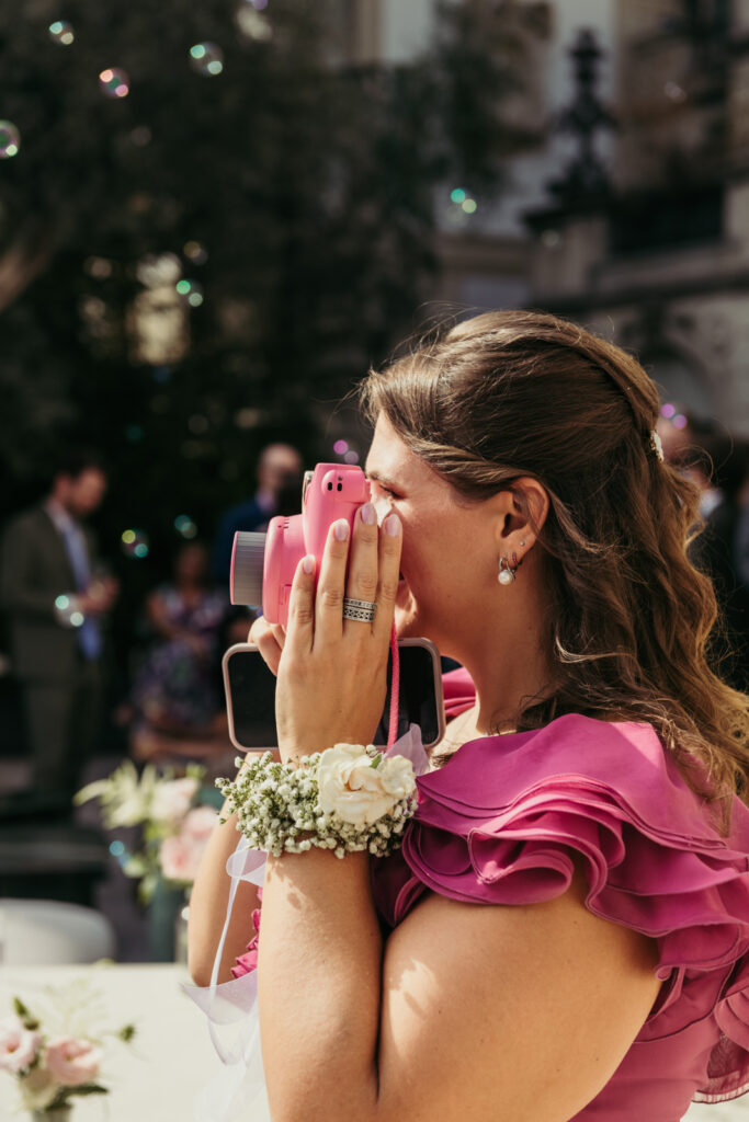 Bridesmaid with corsage smiling emotionally during the wedding speeches