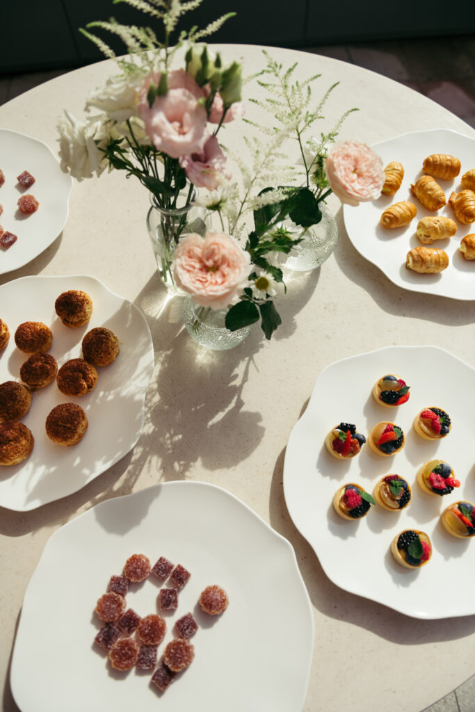 Wedding appetizers and mini desserts displayed elegantly on a white table