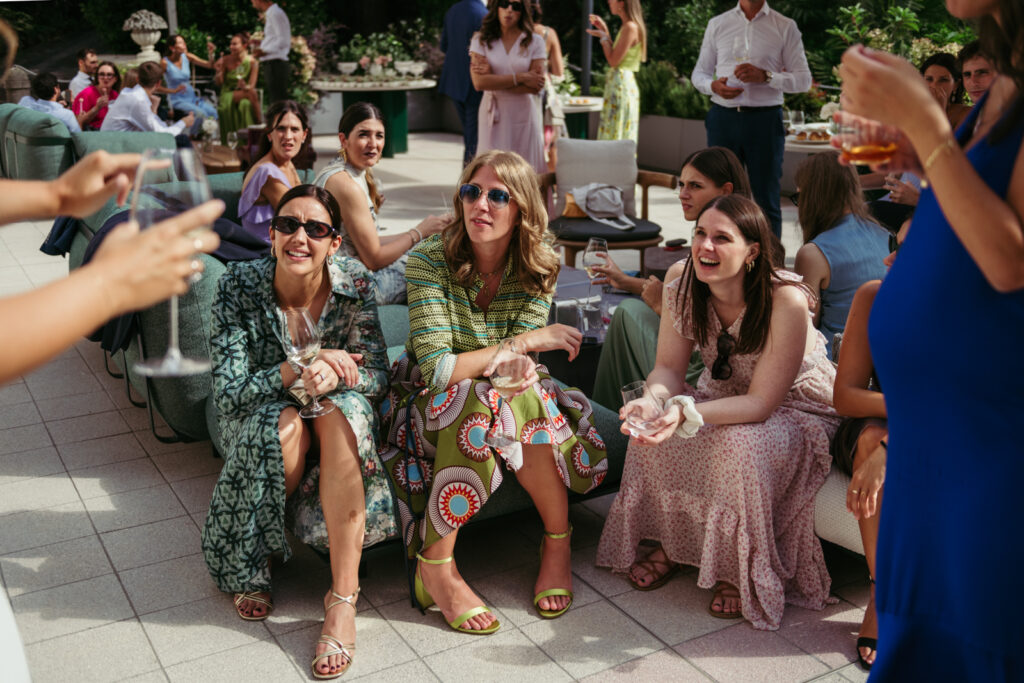 Wedding guests sitting and smiling during the outdoor reception at Villa Elena