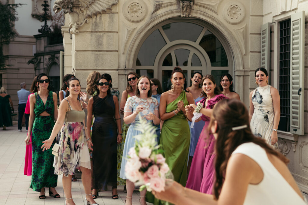 Group of female guests getting ready to catch the bouquet during the wedding
