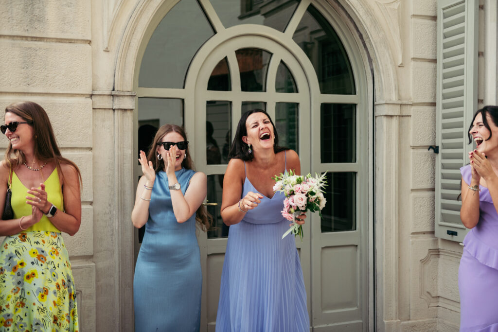 Bridesmaids waiting for the bouquet toss outside the Italian villa
