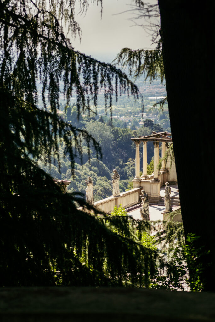 Italian villa architecture peeking through trees at an outdoor wedding in Bergamo