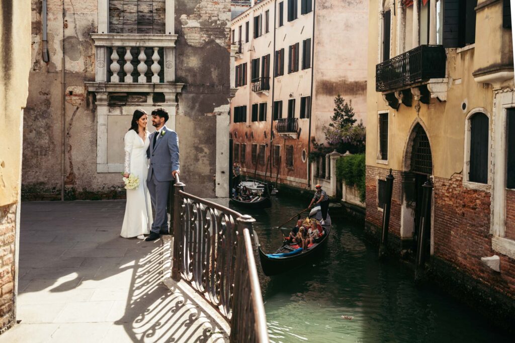 Elopement portrait of couple on a Venetian bridge with warm sunset light