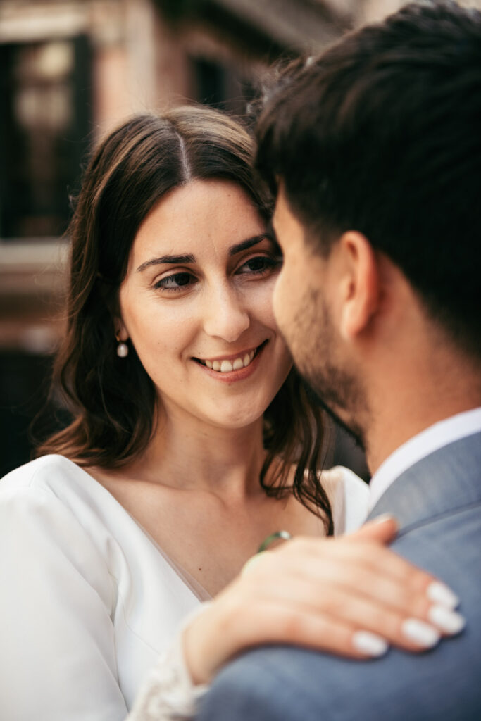 Bride looking lovingly at groom during their elopement in Venice