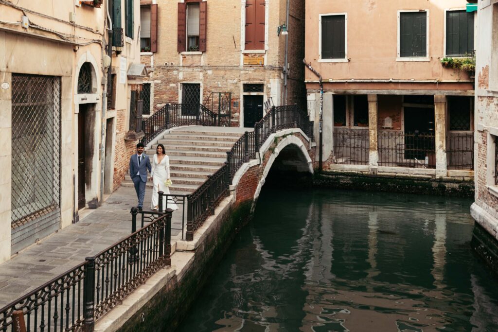 View of Venetian bridge over quiet canal near elopement ceremony location