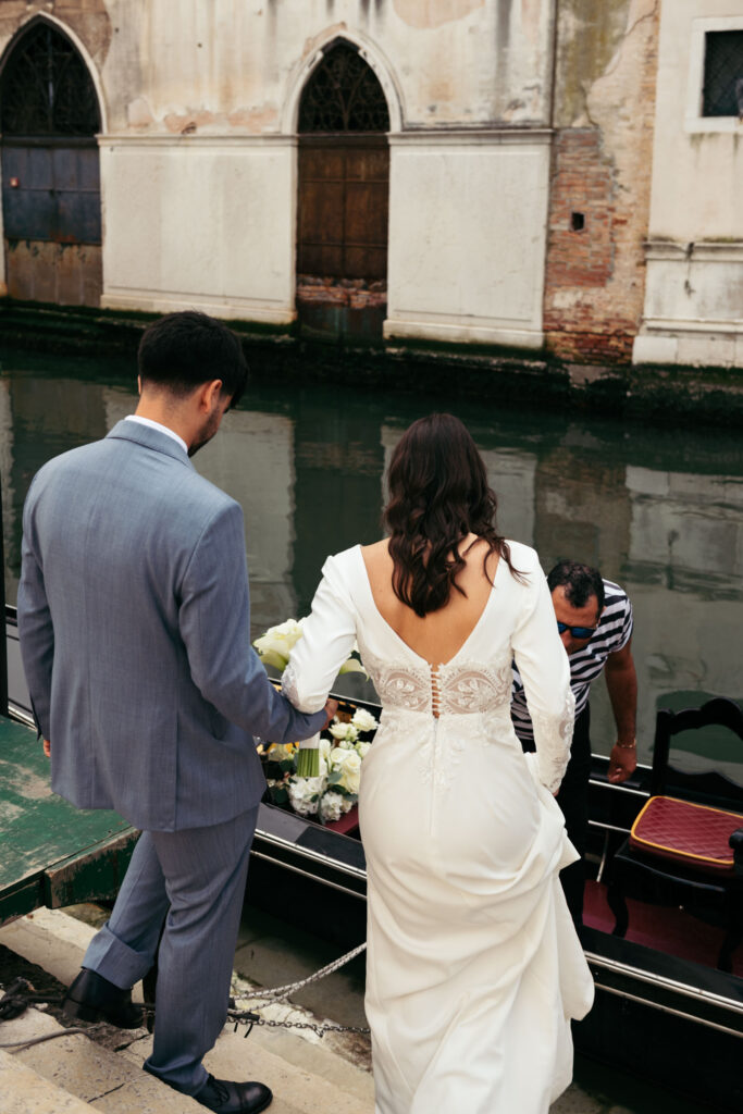 Bride and groom getting on the gondola for their symbolic ceremony in Venice Italy