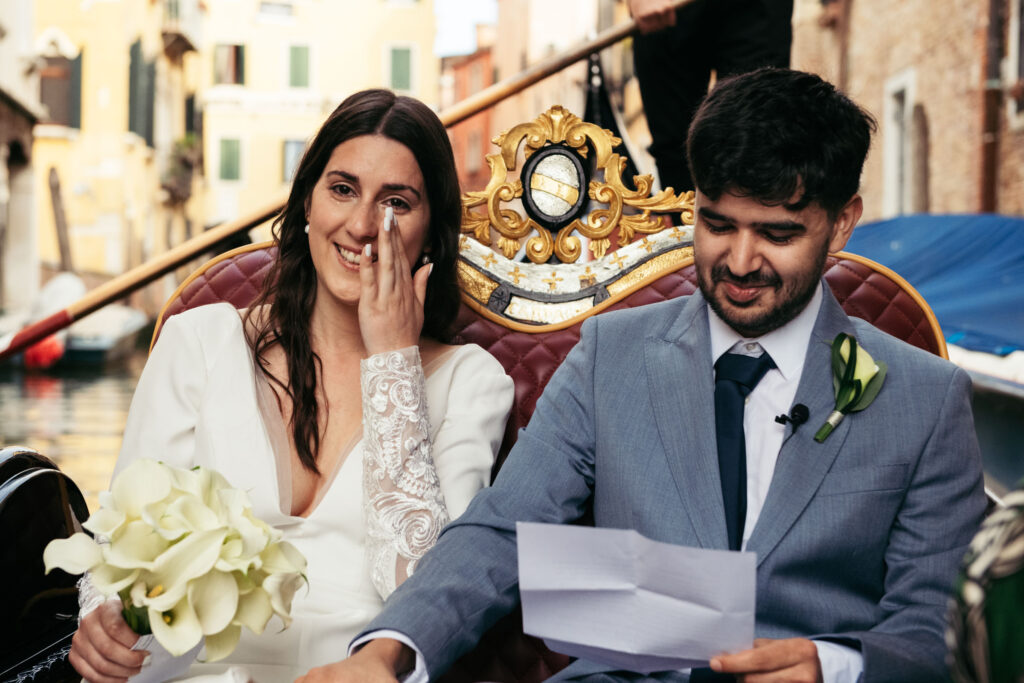 Bride getting emotional while reading her vows during symbolic gondola wedding in Venice