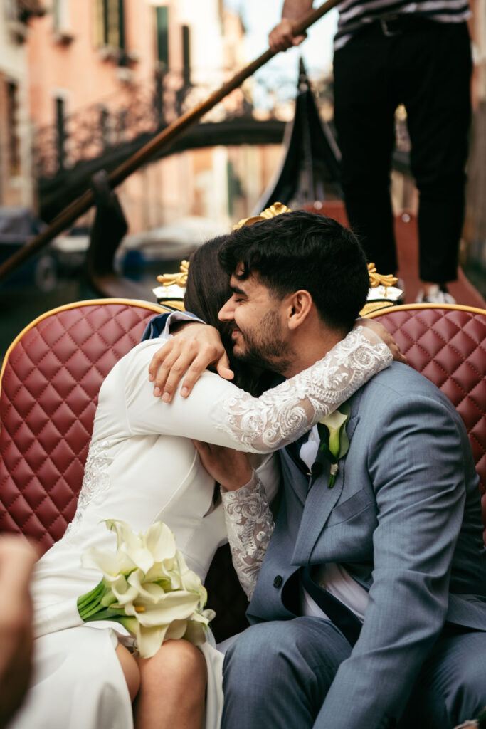 Bride and groom share a kiss after their symbolic gondola wedding in Venice