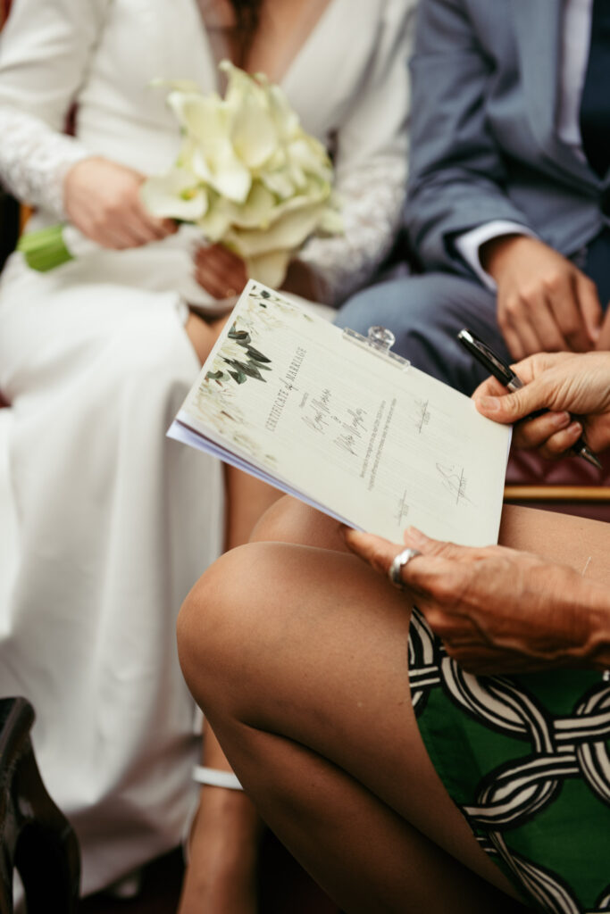 Close-up of symbolic marriage certificate being signed on a gondola in Venice