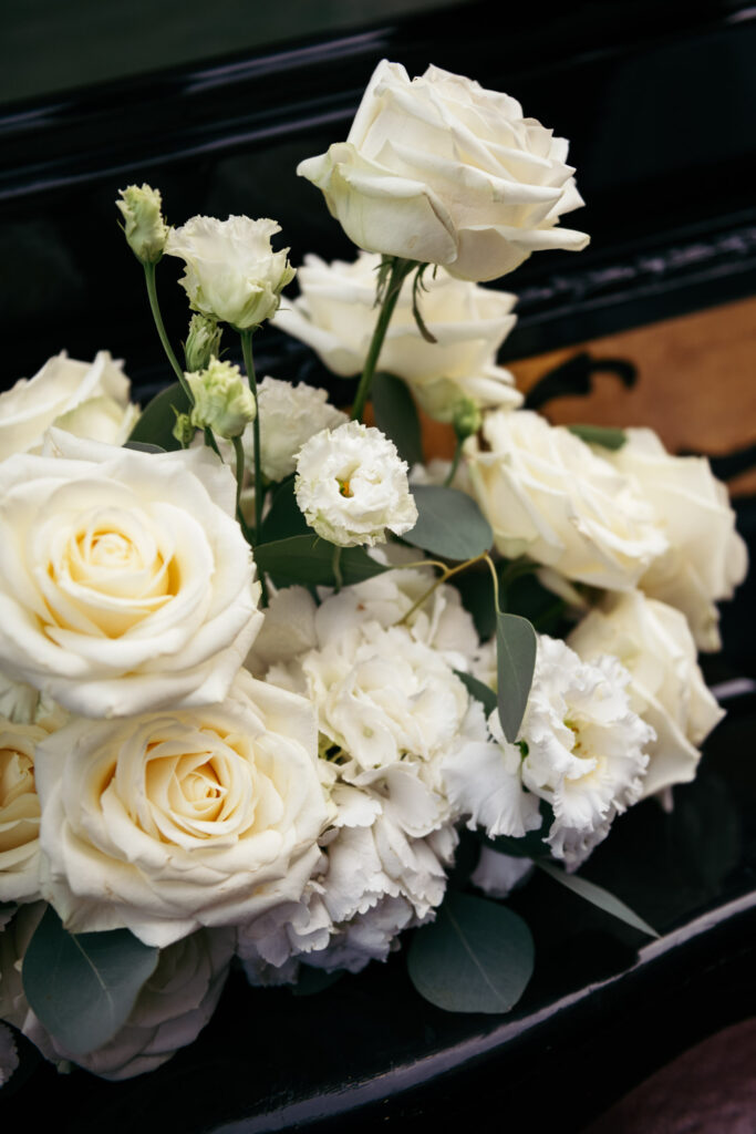Close-up of white roses and floral arrangement used for a gondola elopement ceremony
