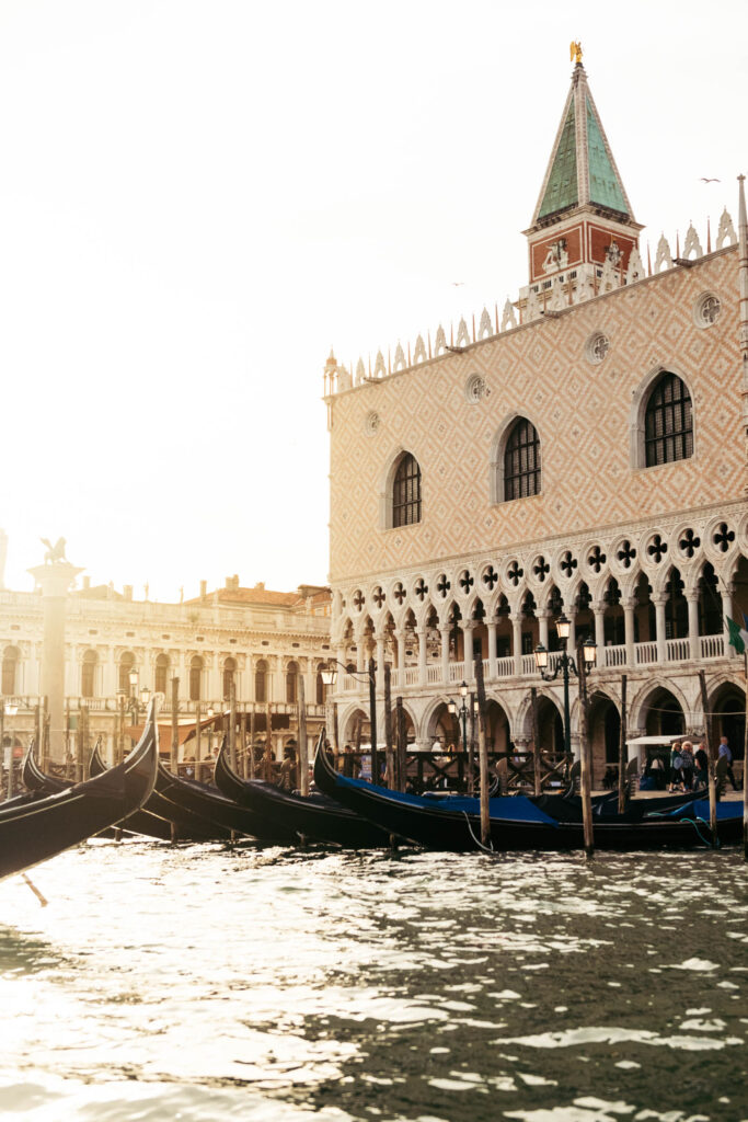 Gondolas docked near Doge's Palace at sunset during a symbolic wedding in Venice