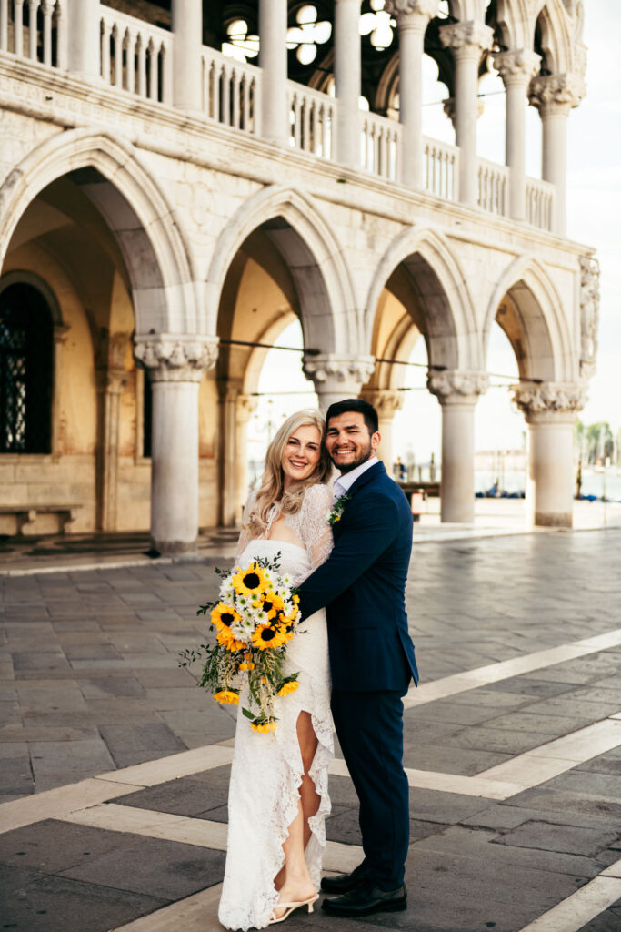 Groom embracing the bride with soft morning light in Venice’s historic center