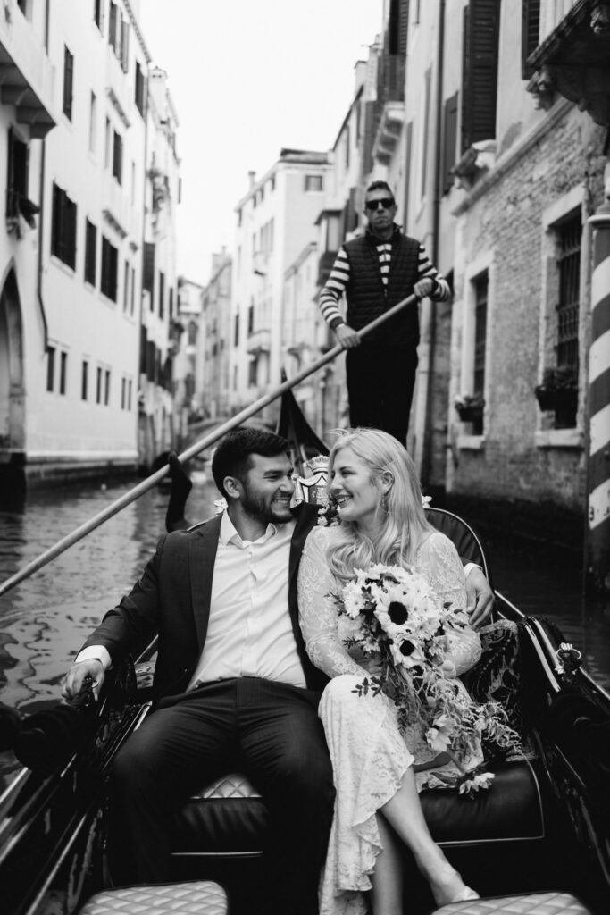Black and white gondola portrait of bride and groom during their symbolic elopement in Venice
