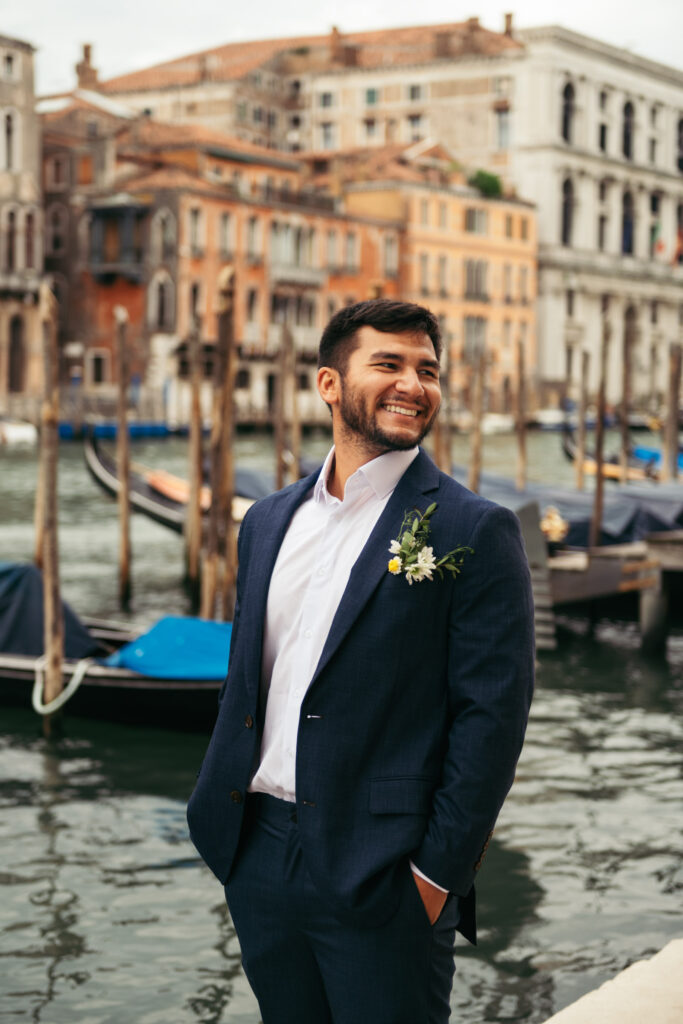 Groom laughing candidly during the morning of their elope in Venice